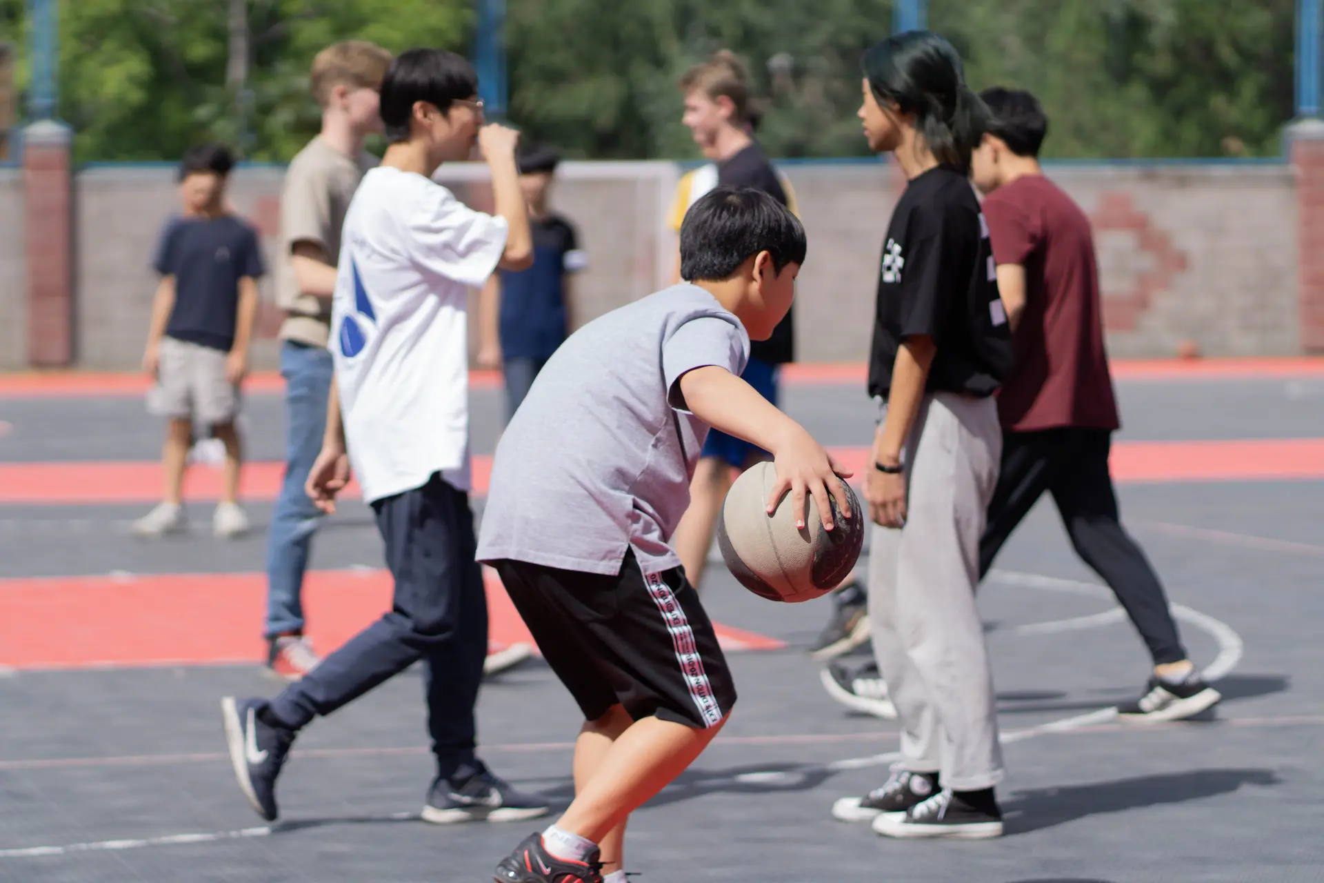 Student playing on the basketball court